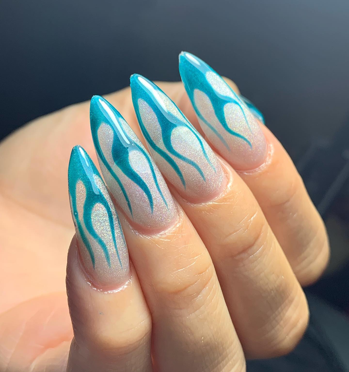 Is there a happier and calmer color than turquoise? For your flame nails, this color is a great choice. Long stiletto nails are taken to a whole different level and you will be on fire with this nail art.