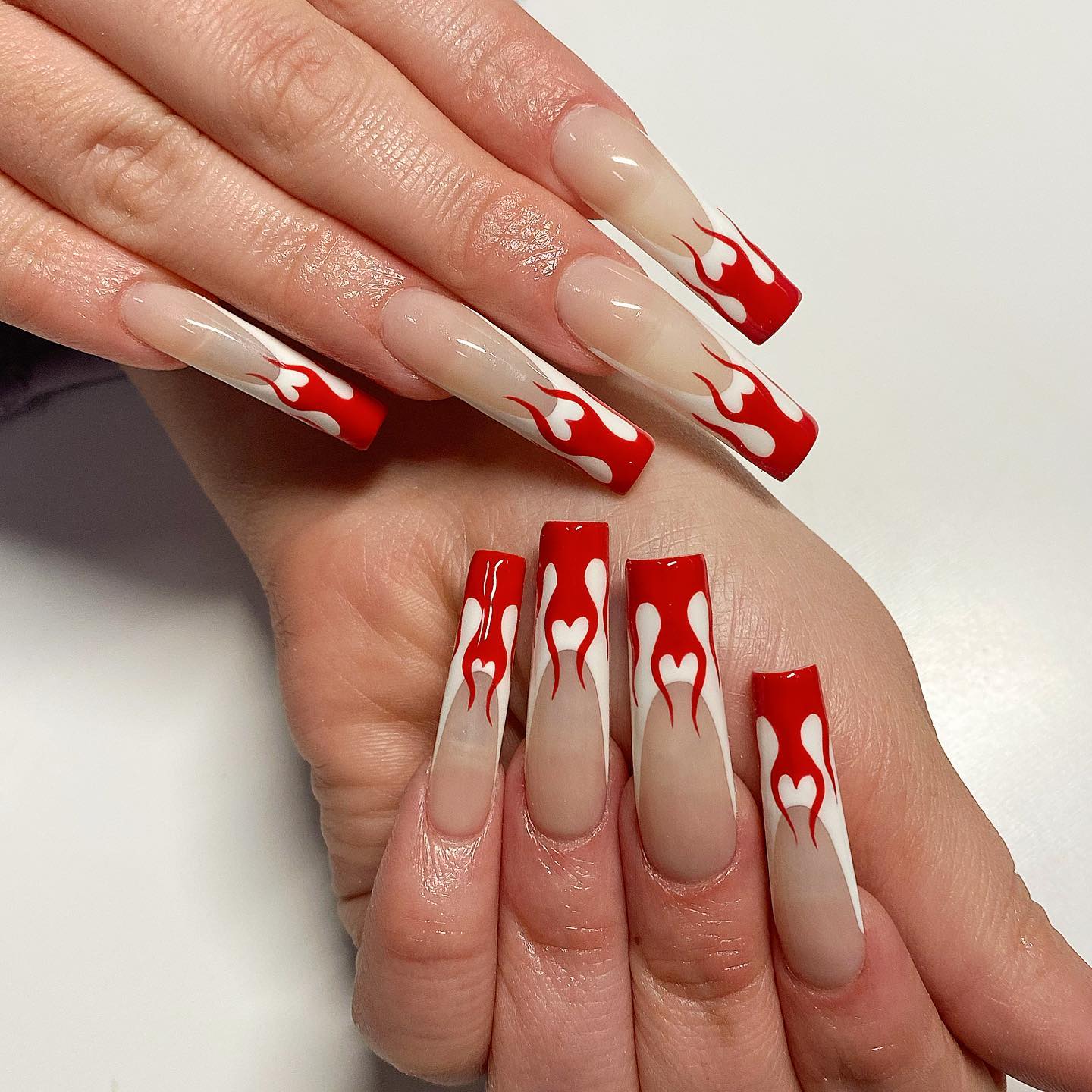 Long acrylic square nails require boldness to get, right? If you are bold enough to get them, let's take your boldness to another level with red flame nail art. They're gonna shine on your French mani.