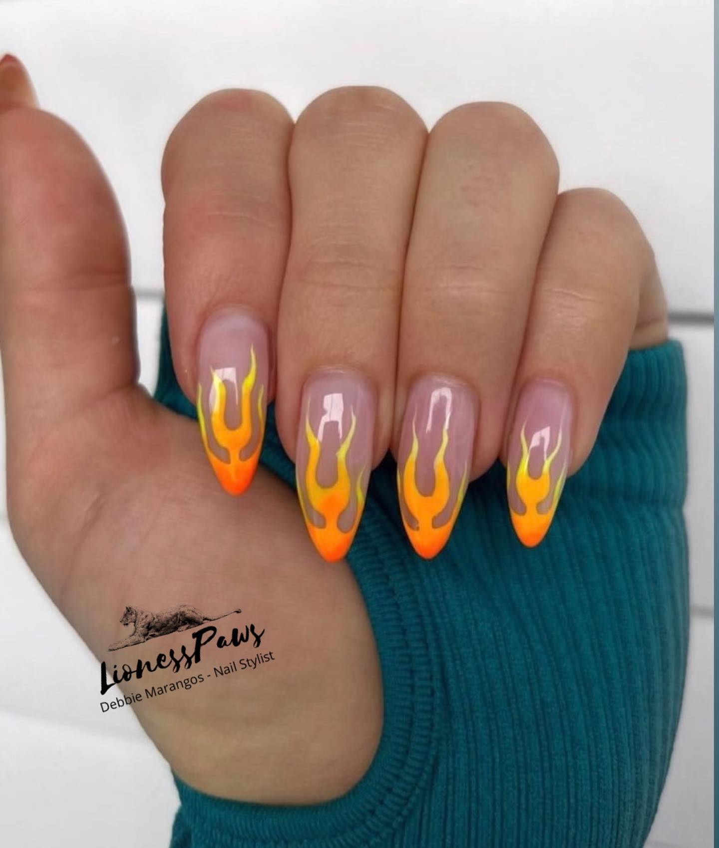 When it comes to talk about summer nails, there is no better color than orange. Let's go for a nude nail polish and draw orange flames that go lighter from tips. Everyone will realize your nails and want to check them closely.
