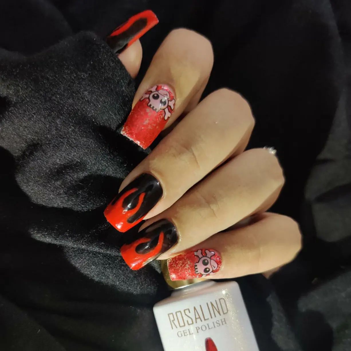 Here is a black and red nail combo that sparkles. These nails can be a nice option for Halloween, too since it includes skull faces for accent nails. You will feel sexy with these for sure.