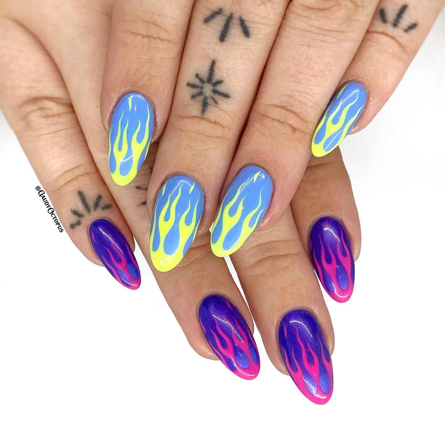 Have you ever seen more colorful flame nails than the ones above? If you like to apply different nail polishes, this nail art idea is for you. On a baby blue base, yellow flames are used while pink ones are used on a dark blue base. You will be on fire with them!