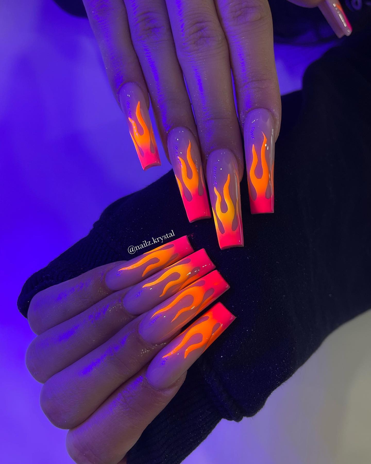Wanna have nails that are brighter than the actual Sun? Then, this flame nail design is for you. Having neon orange flames with a pink French tips is a great way to stand out with your nails.