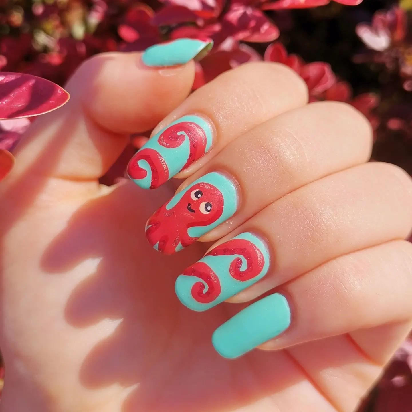 Creativity always wins! Here is a creative nail design that will make you smile. All you need to do is apply turquoise matte nail polish and draw a pinky octopus that stretches to your four nails. Plus, octopuses symbolize creativity and intelligence.