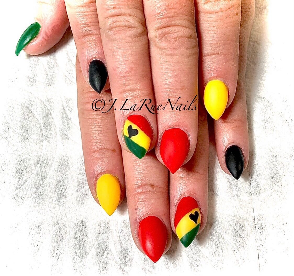 Also known as Jamaican nails, rasta nails feature fantastic color palette that is sure to help you stand out. In these stiletto nail design, Jamaican flag colors are used and a little cute heart is placed on them. Looking stunning and different is quite easy with them.