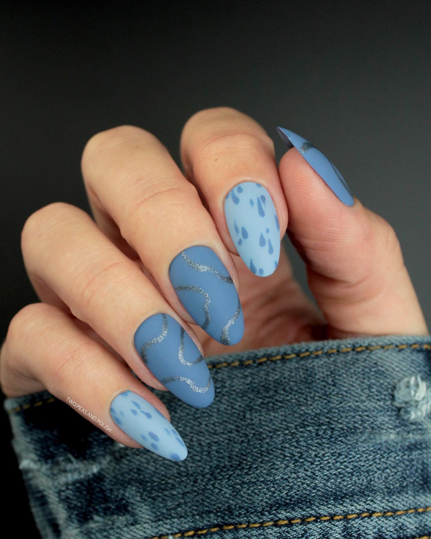 Raindrops nail art is a new but a creative art. In this design, raindrops look like they have dropped on the nails. Plus, silver swirls offers a chic look on blue matte nail polish.