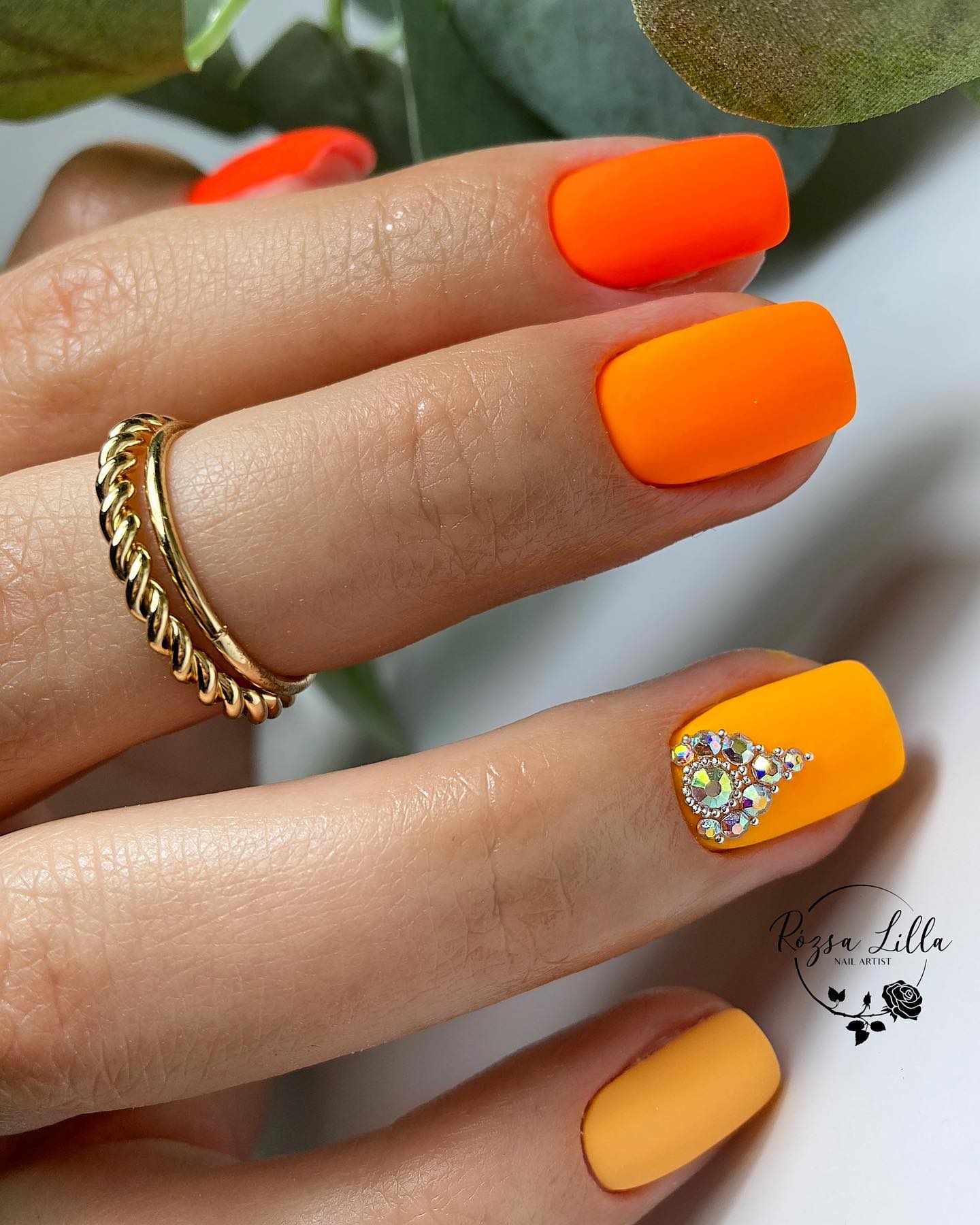 Orange is a very vibrant color so you can get a lot of variation from it. Now it is time to apply different shades of it on your nails together. Short matte orange nails will take your mani to a different level with a shiny stone on accent nail.