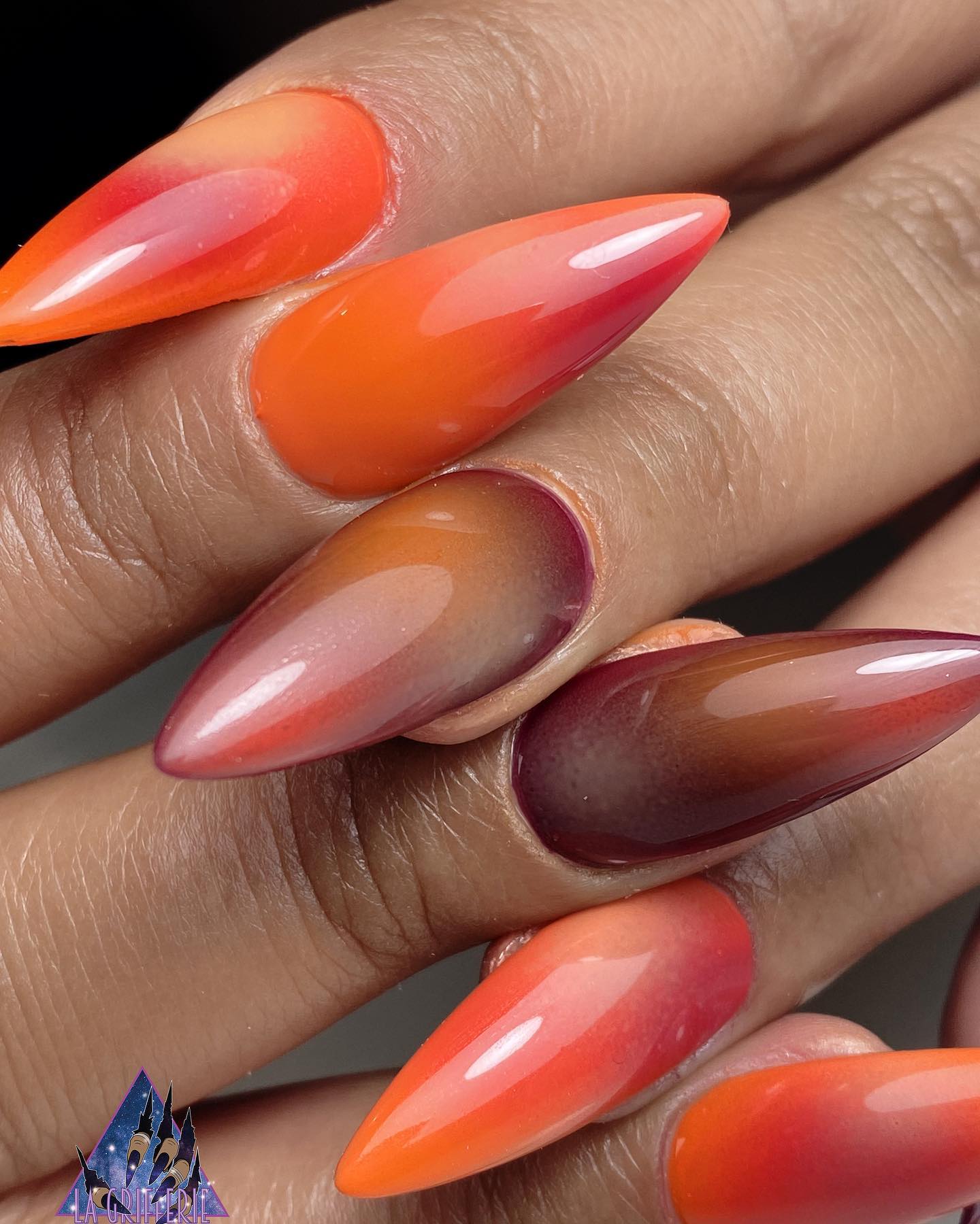 Orange stiletto nails are a fun way to show off your individuality! You can wear them on their own, or pair them with another color like purple or red like the one above. The possibilities are endless!
