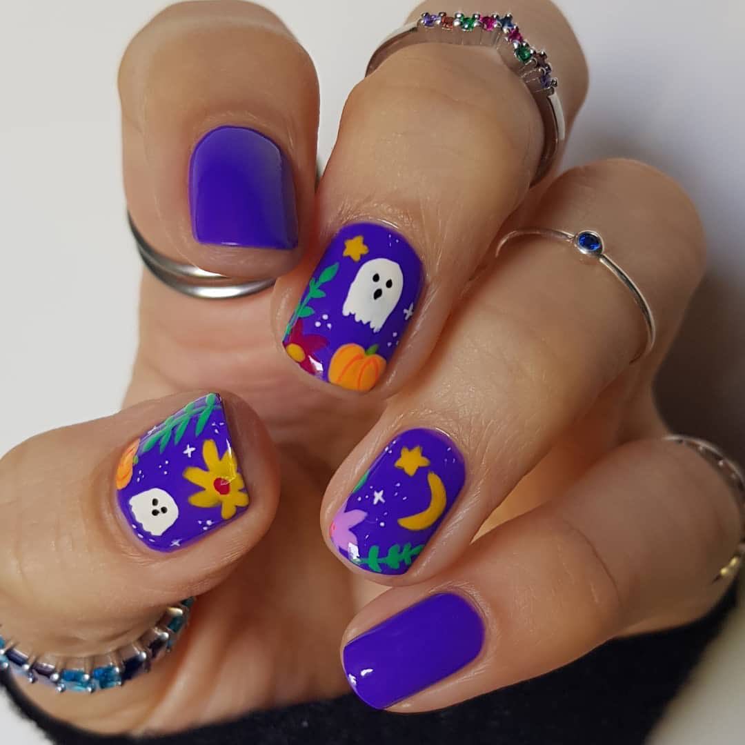 Do you like purple and Halloween at the same time? Then, you need to have a Halloween manicure that incorporated both of those things. To create a contrast with this time of the year, you can get a cute nail art on your accent nails which are full of ghosts, pumpkins and stars.
