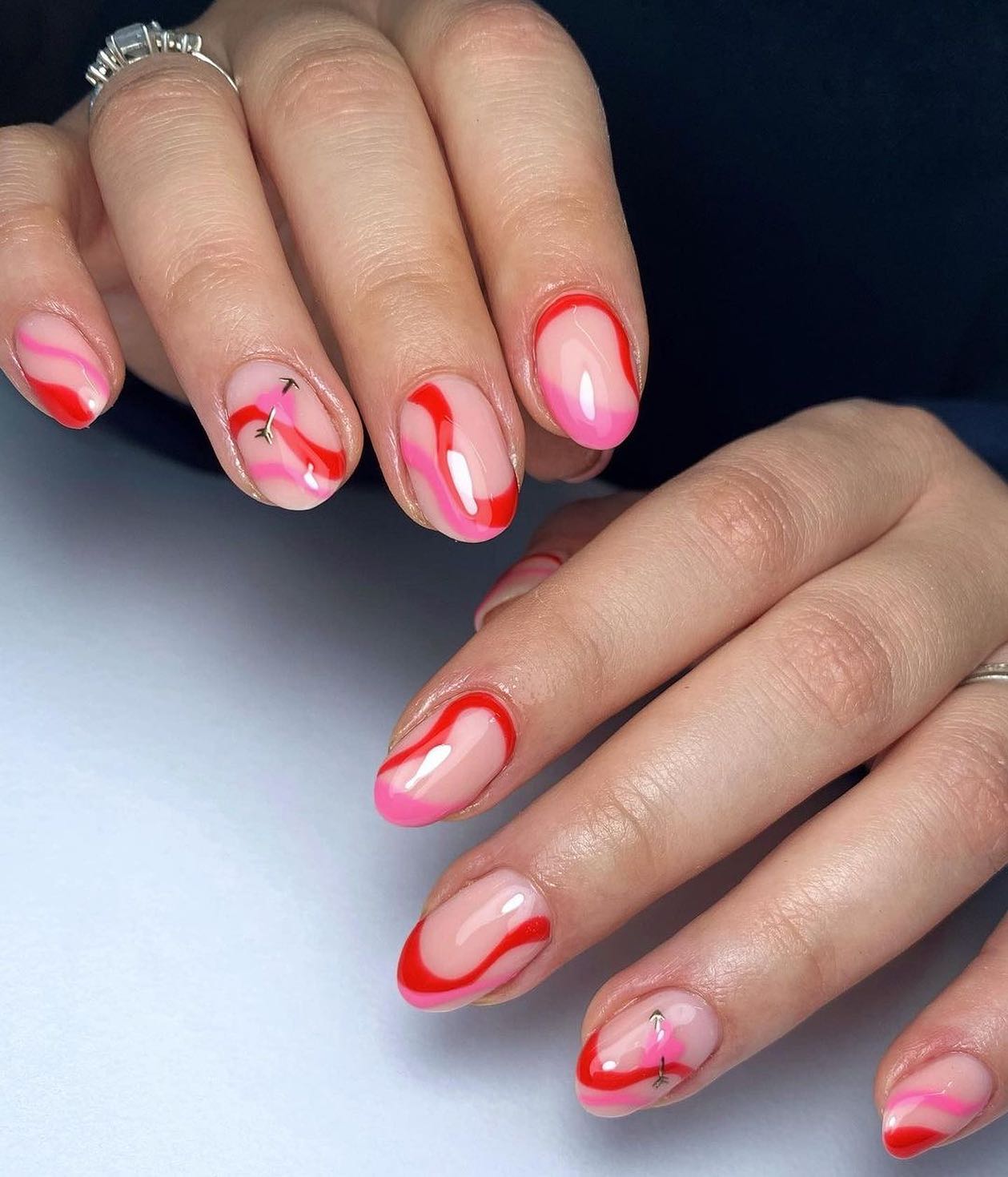 The red and pink swirl nail art is so fabulous and fun! You can create this look by using a small brush to draw on swirls. The trick is to make sure that you're using gel polish so that your design won't fade quickly.