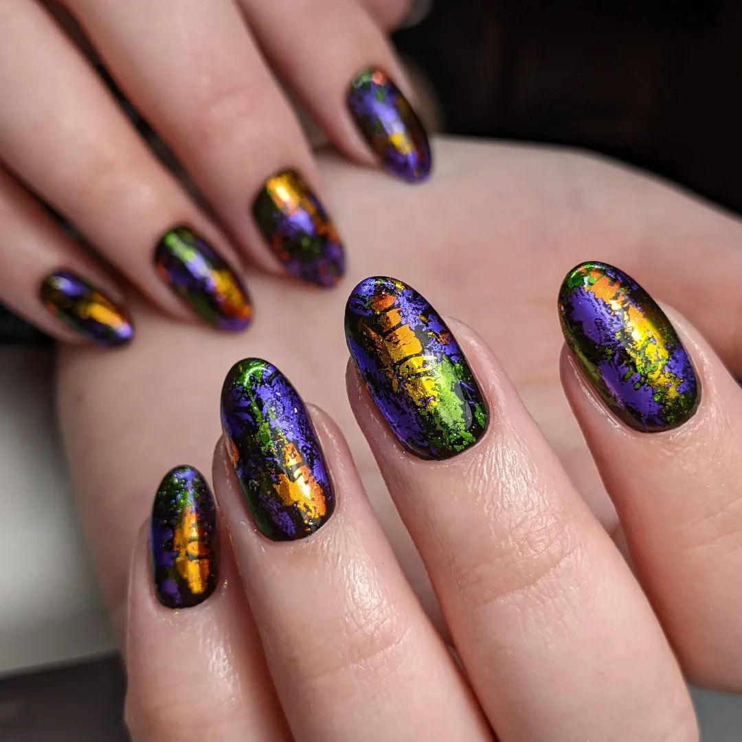 We are sure that you will adore this strange nail design! Green, yellow, orange and purple are combined together to create such a strong nail design in this work. With its abstract look, this shiny nails will help you stand out in the crowd easily.