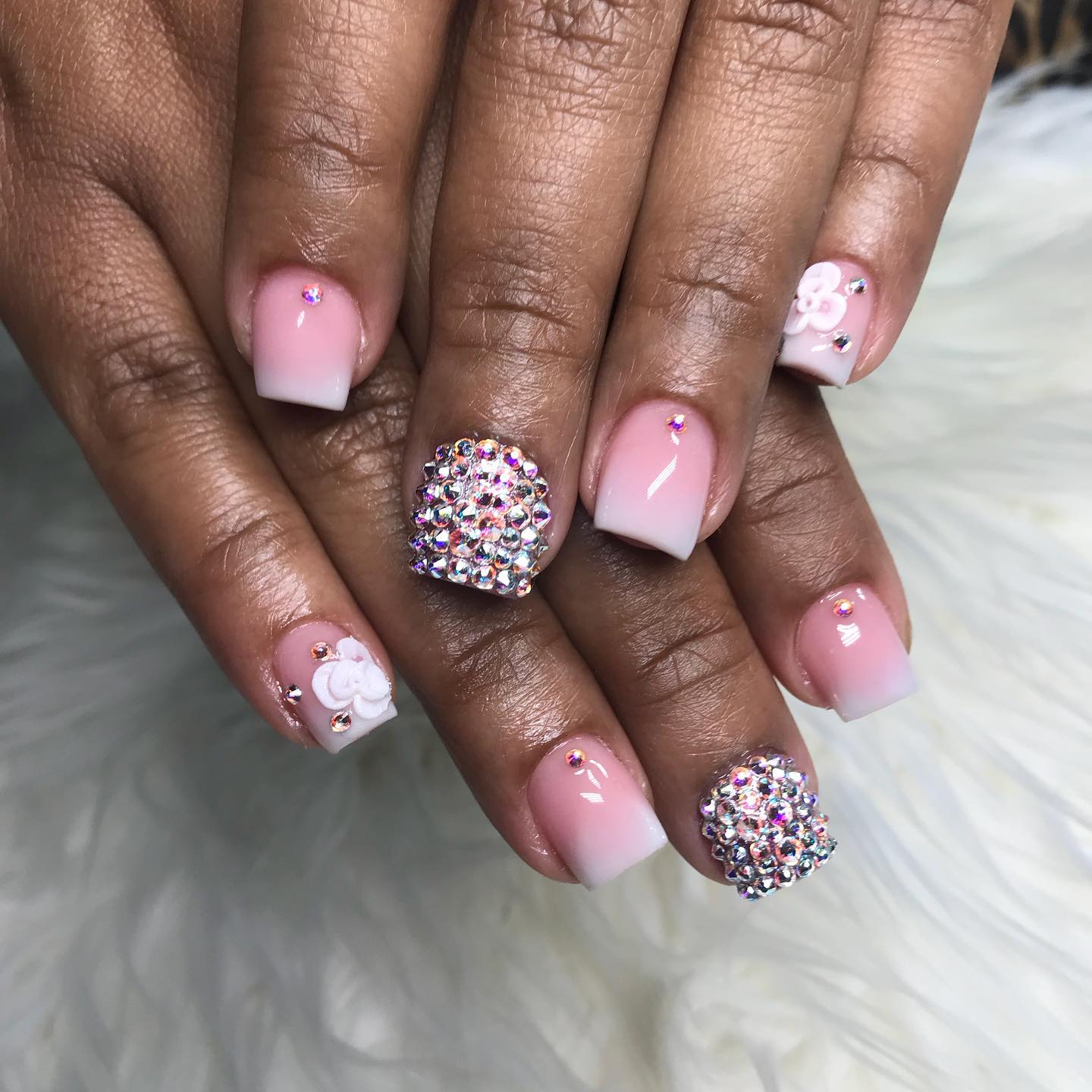 Here is another example of pink and white ombre nails with an accent nail that is covered in stones. This accent nail can help you catch attention to your ombre nails easily. Plus, you don't have to have long nails since they also look great on your short nails.