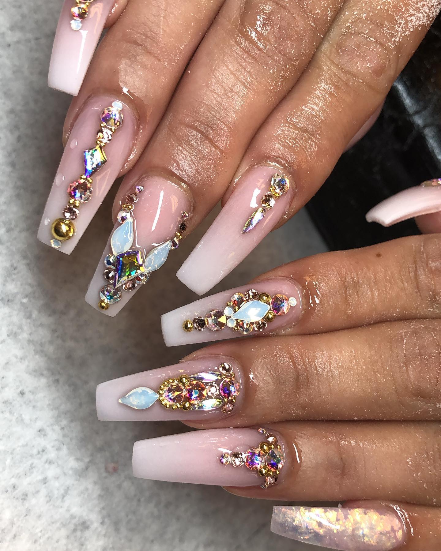 If you are a woman who always wants to get more of everything, this pink and white ombre nail design is definitely for you. For your long square ombre nails, let's add shiny and colorful gems to show everyone that you are a true princess.