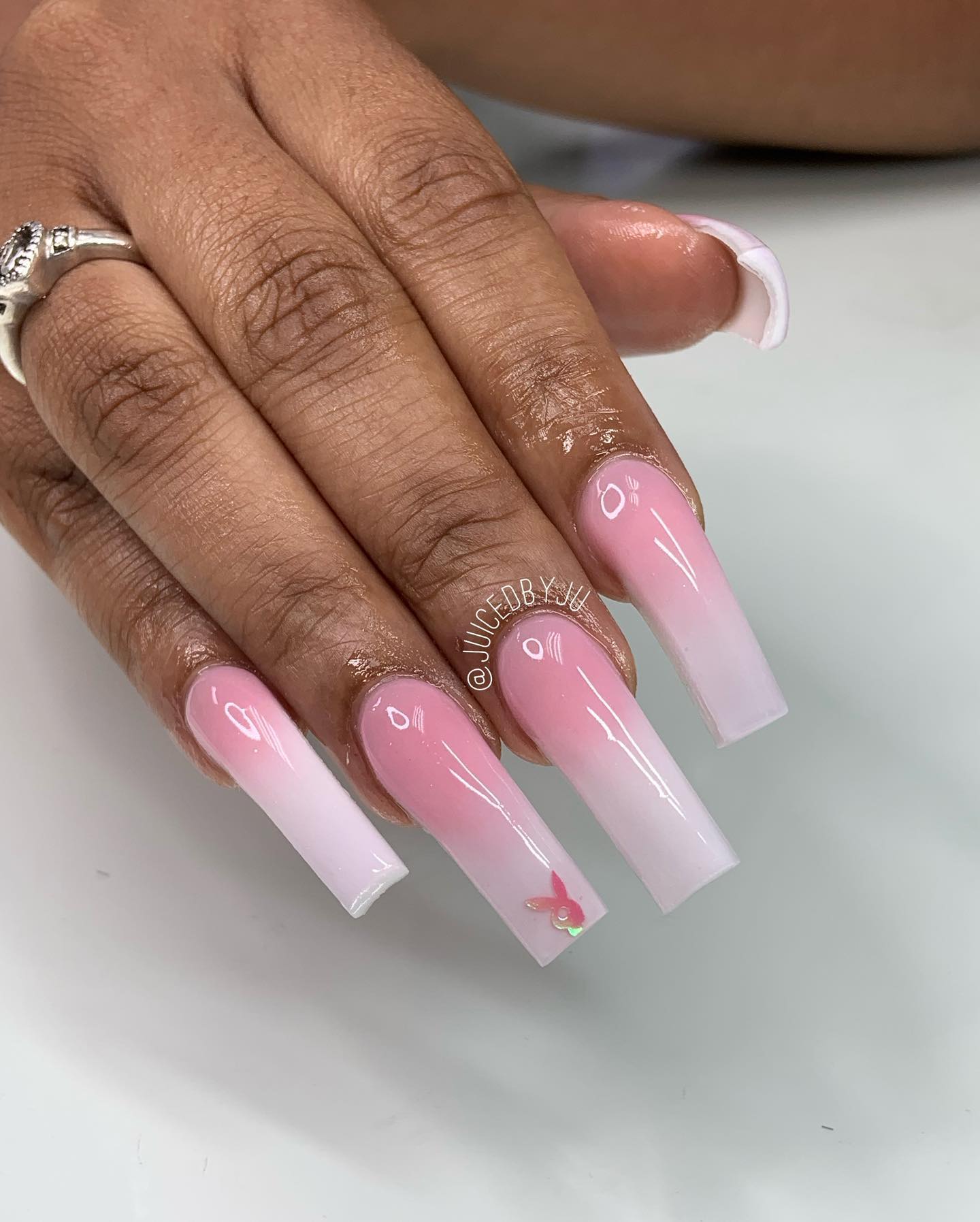A thick and long acrylic nail shows off your personality a lot but there is always something you can add to your nail design. Go for a baby pink and white ombre nails and stick a playboy bunny nail sticker to your ring finger.