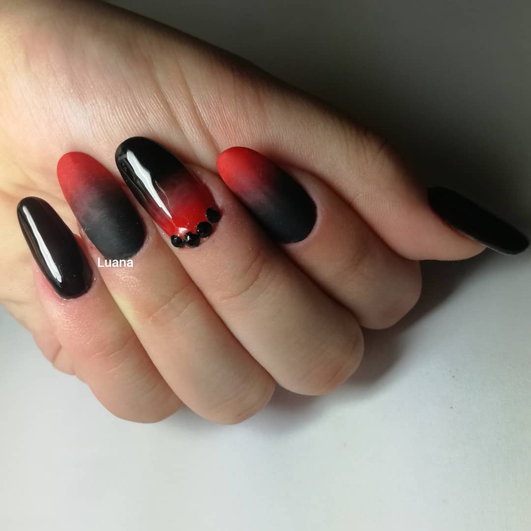 The fading effect looks so real and the transition between black and red is a work of a talented nail artist. The other nails are shiny and if you add little black stones, everyone will notice your nails, for sure.
