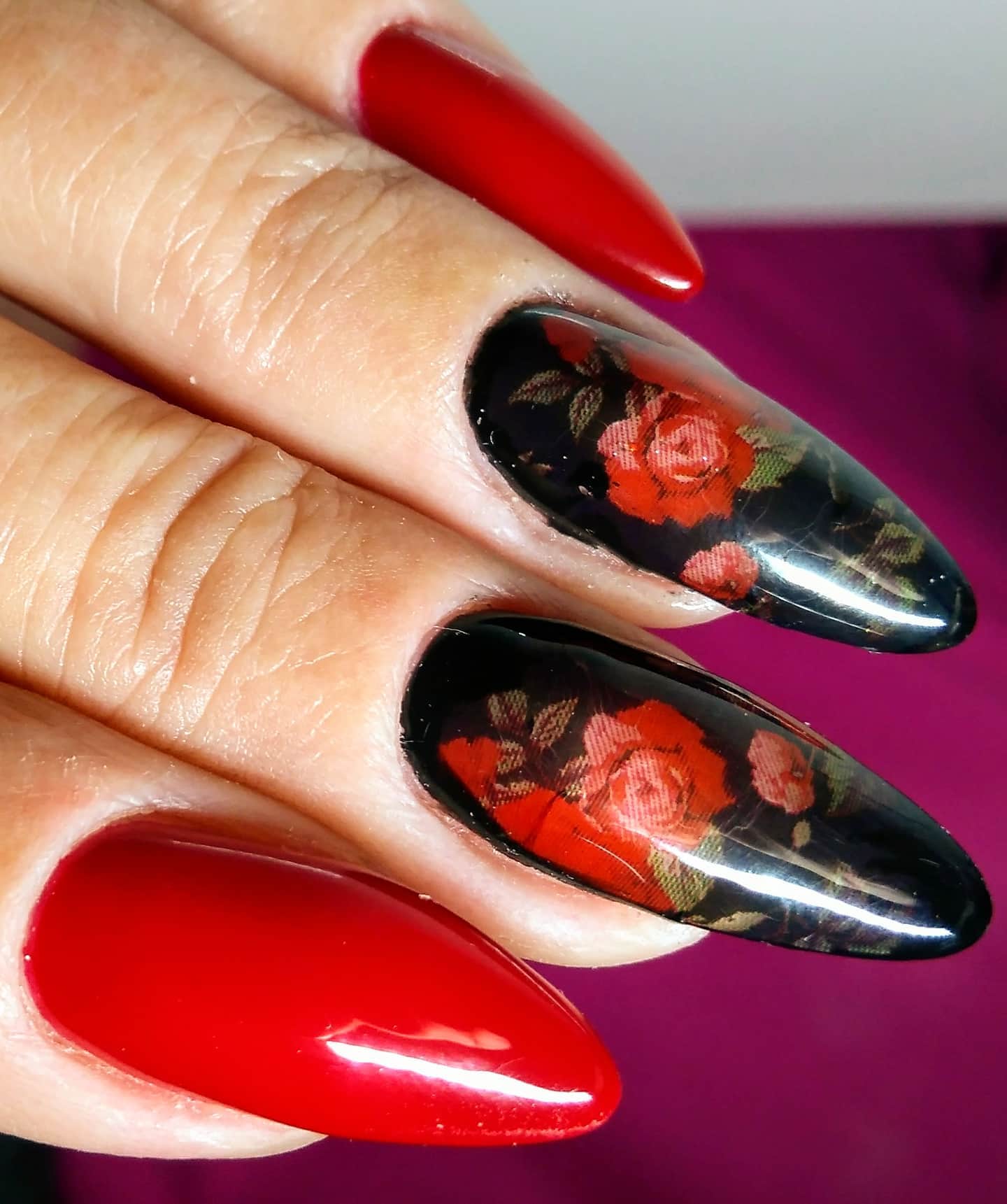 A chic rose nail design can be all you need to get to look amazing with your long almond nails. This design has a vintage vibe due to its look and this is what makes it unique. The black base behind makes the roses stand out.