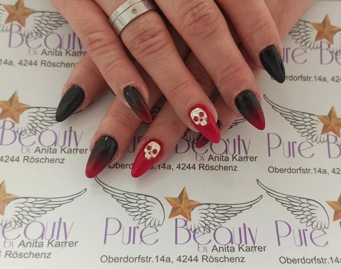 The symbol of mortality, a skull, is one of the most iconic figures. A white skull on your blood red nail polish will look amazing with your black and red ombe nails.