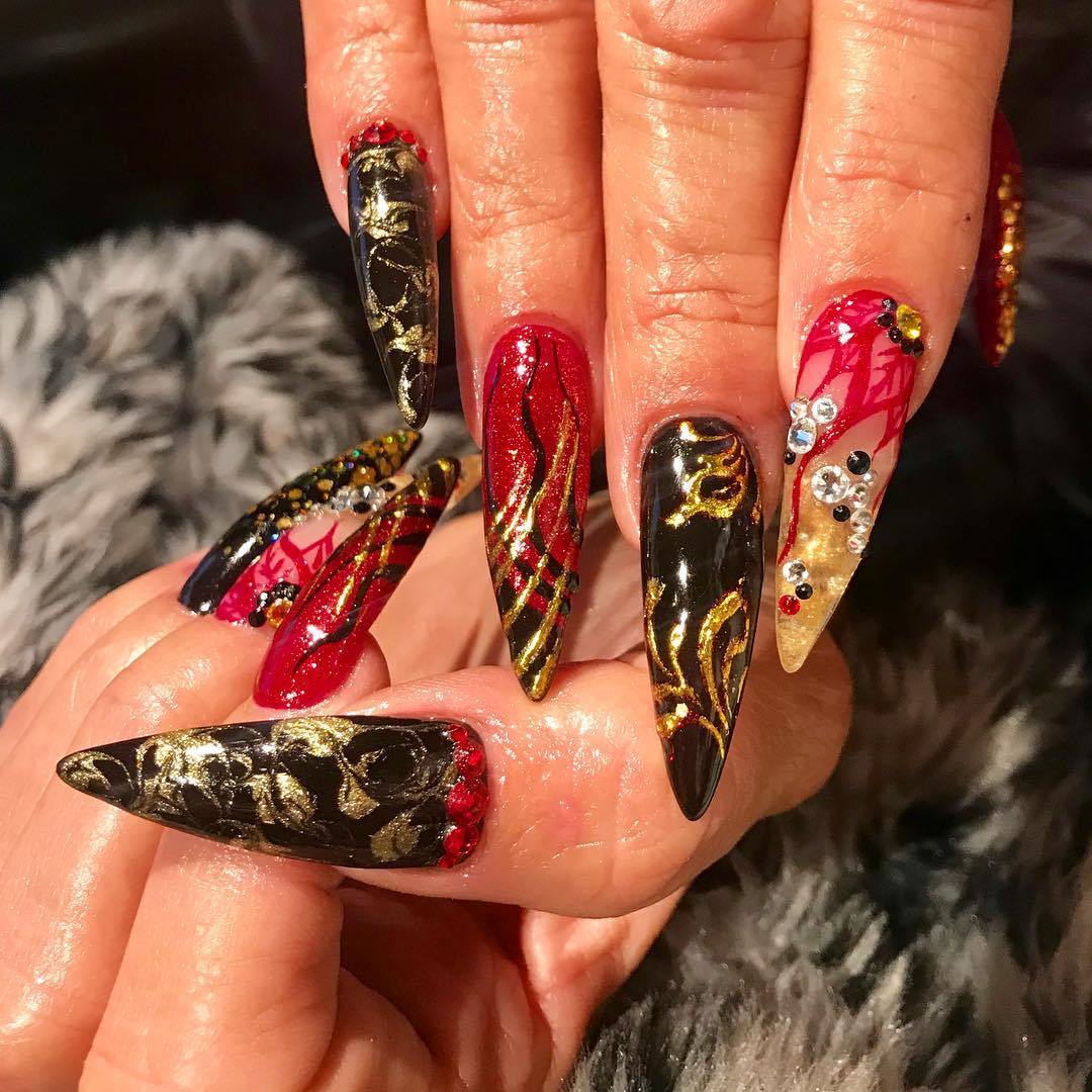  Nail art is a type of artwork and we all know that you can be as creative as possible. The example above is a mixture of black, red and gold. And it looks like a piece of art, like a canvas.