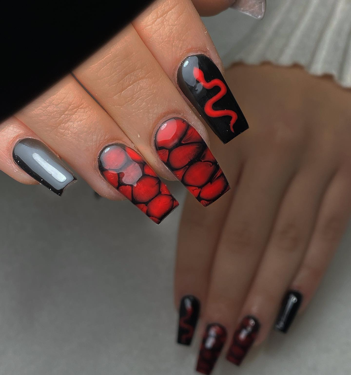 Snake is a timeless symbol and it is used in many designs just like nail ones. When you add this symbol with a red nail polish, you will get the savage feeling to the fullest. As a nice detail, snake skin is used.