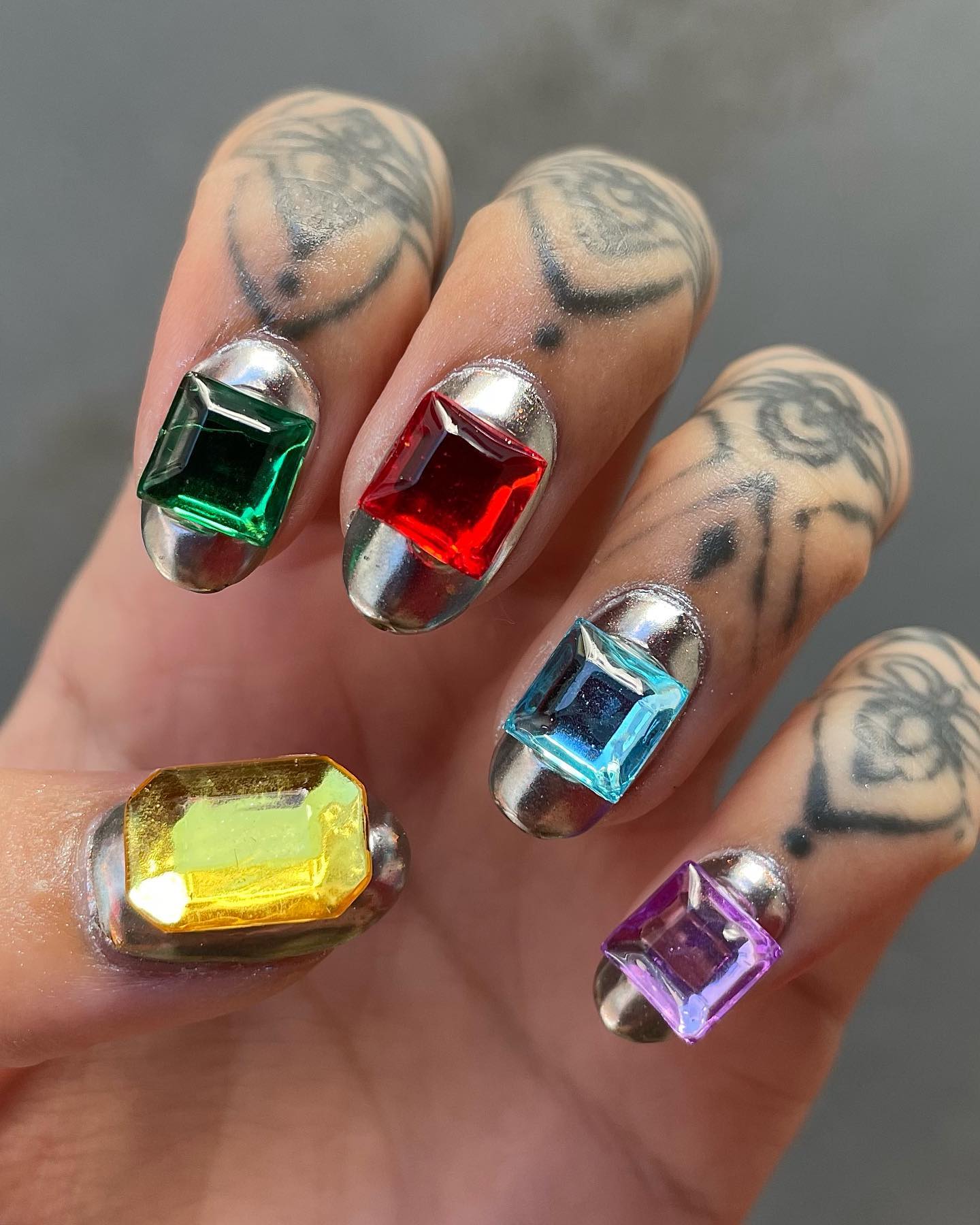 Gem nail art is a type of nail art that uses gems as the main component. In the one above, and metallic silver nail polish is applied and then colorful and big gemstones are added on top of them. If you are going to have a party or a special location, this is the one you should get.