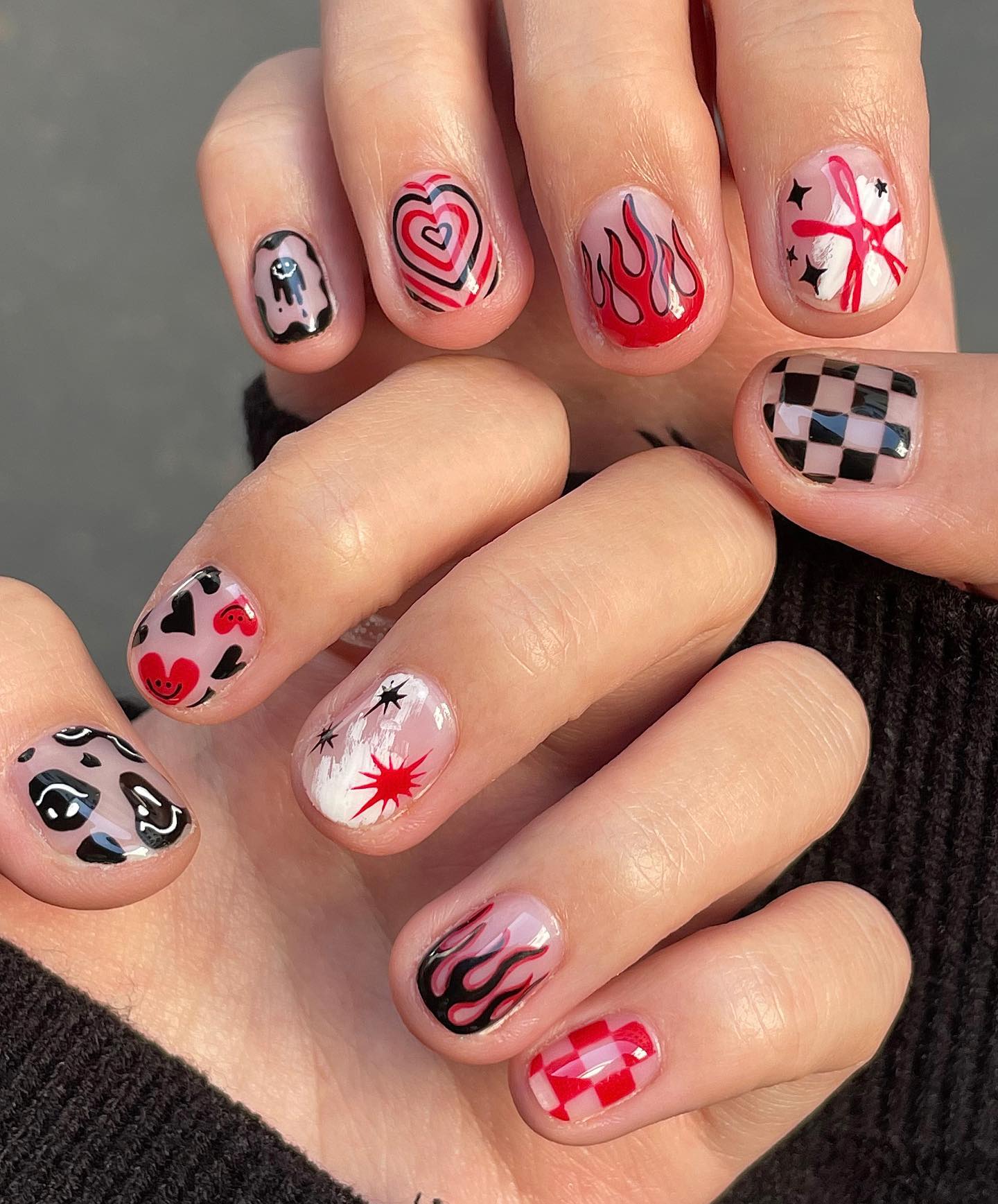 Why don't you apply different and sweet nail art to your each nail? A smiley face and heart smileys are ready to cheer you up while a fire and checkered nail art give an extra beauty to the nails.