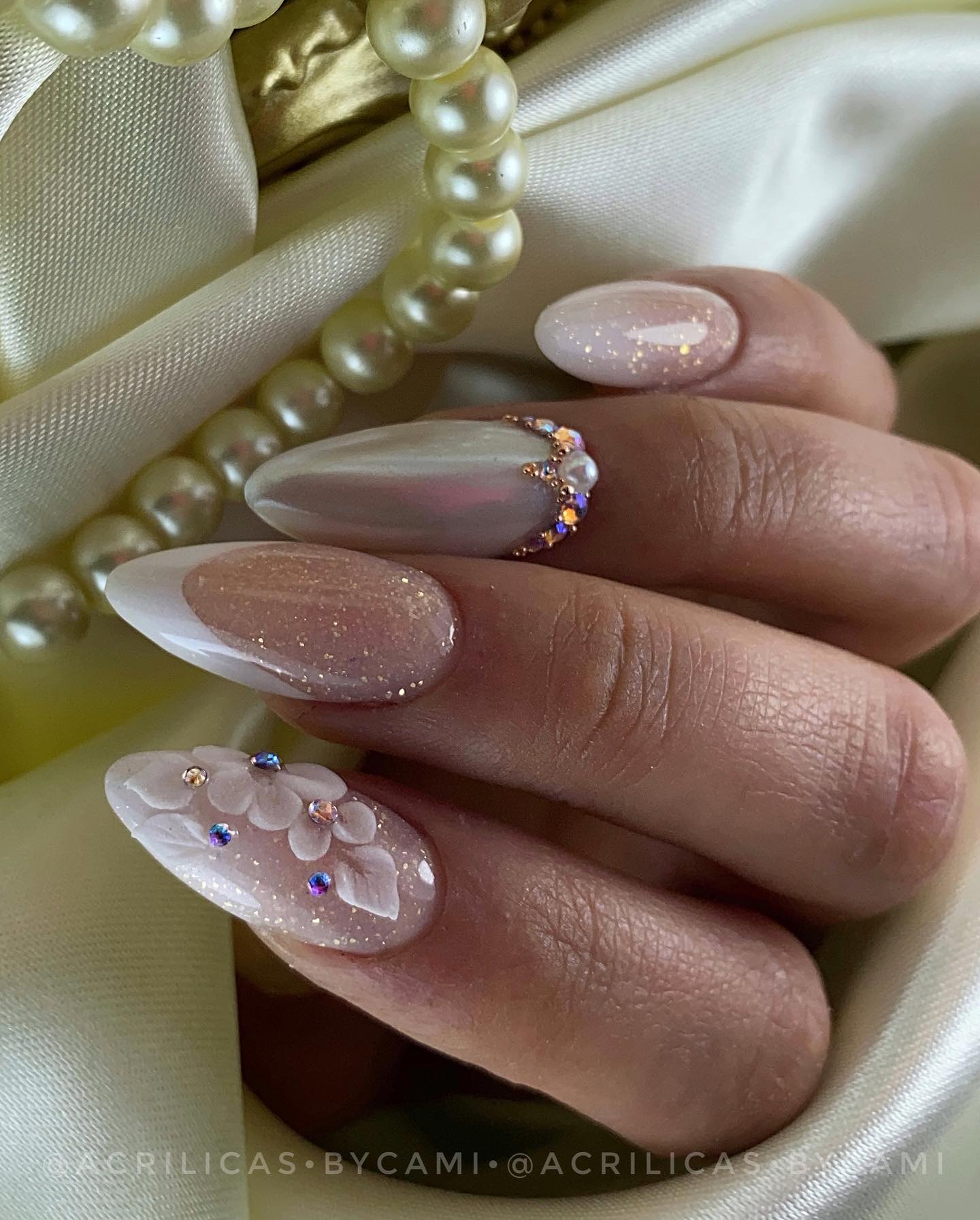 You will be on the spotlight on your wedding day, so your nails will, too. Highly decorated wedding nails are here to make you feel like a princess. Shiny and glittered nail polish looks amazing when it is matched with some stones and flowers.