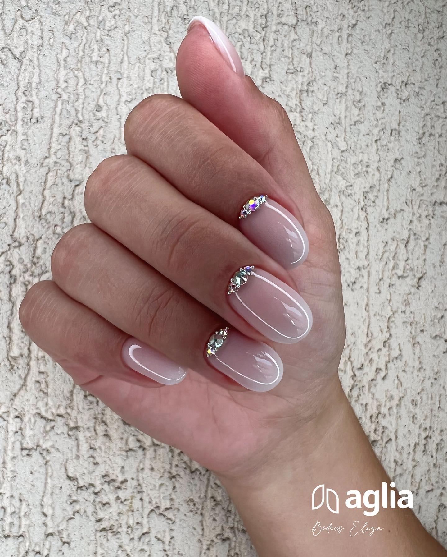 Wanna have have ombre-like nails to look amazing? White ombre nails will be matching with your wedding dress and the shiny stones on top of the three nails give them a quite chic look.