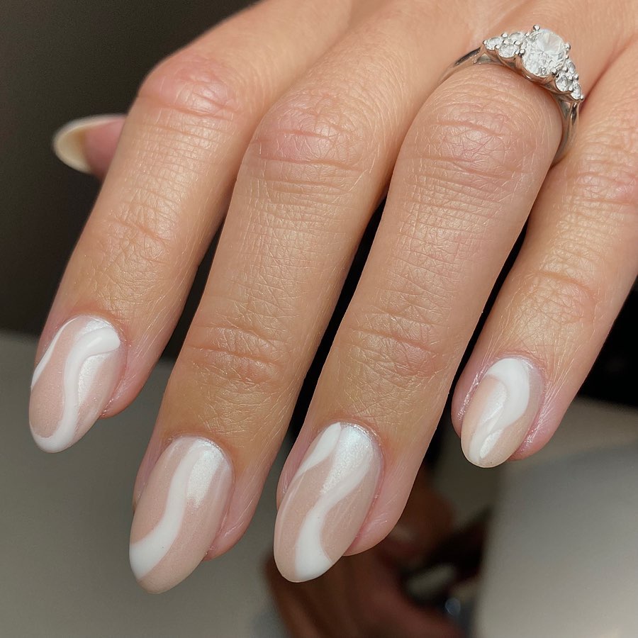 This fresh take on your neutral mani is adorable! A beige nail polish and white swirls on top of it look amazing and it is sure that you will stand out on your wedding day with these.