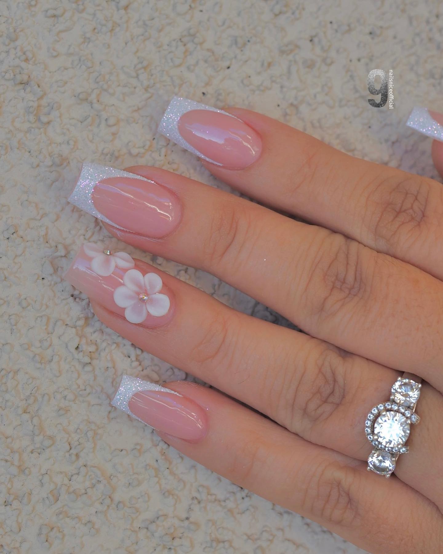 Can you see how glamorous these nails look with a wedding ring? Your gorgeous ring deserves a glittered French mani, so go for it as soon as possible. Daisy stickers add an extra beauty, too.