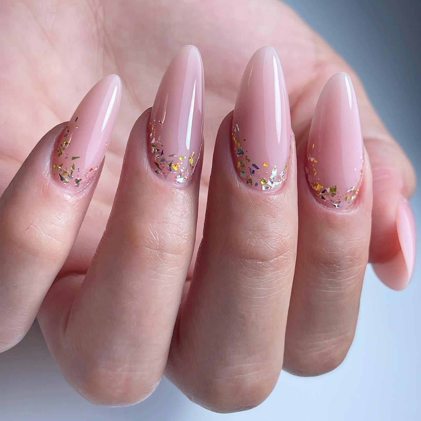 Shiny pinkish nude nail polish is ready to boost your mood with its perfect look. Your purity will be a best match with this color. Let's go and get it.