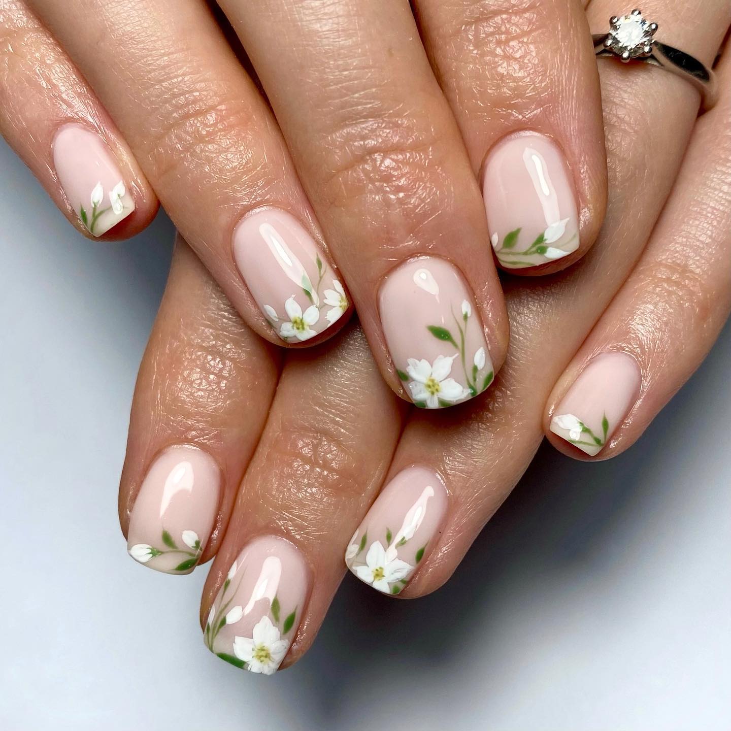 Those who like applying floral nail designs should try these nails out. As a bride, show your innocence with white flowers. The best thing about this design is that the flowers are placed on the tips. 