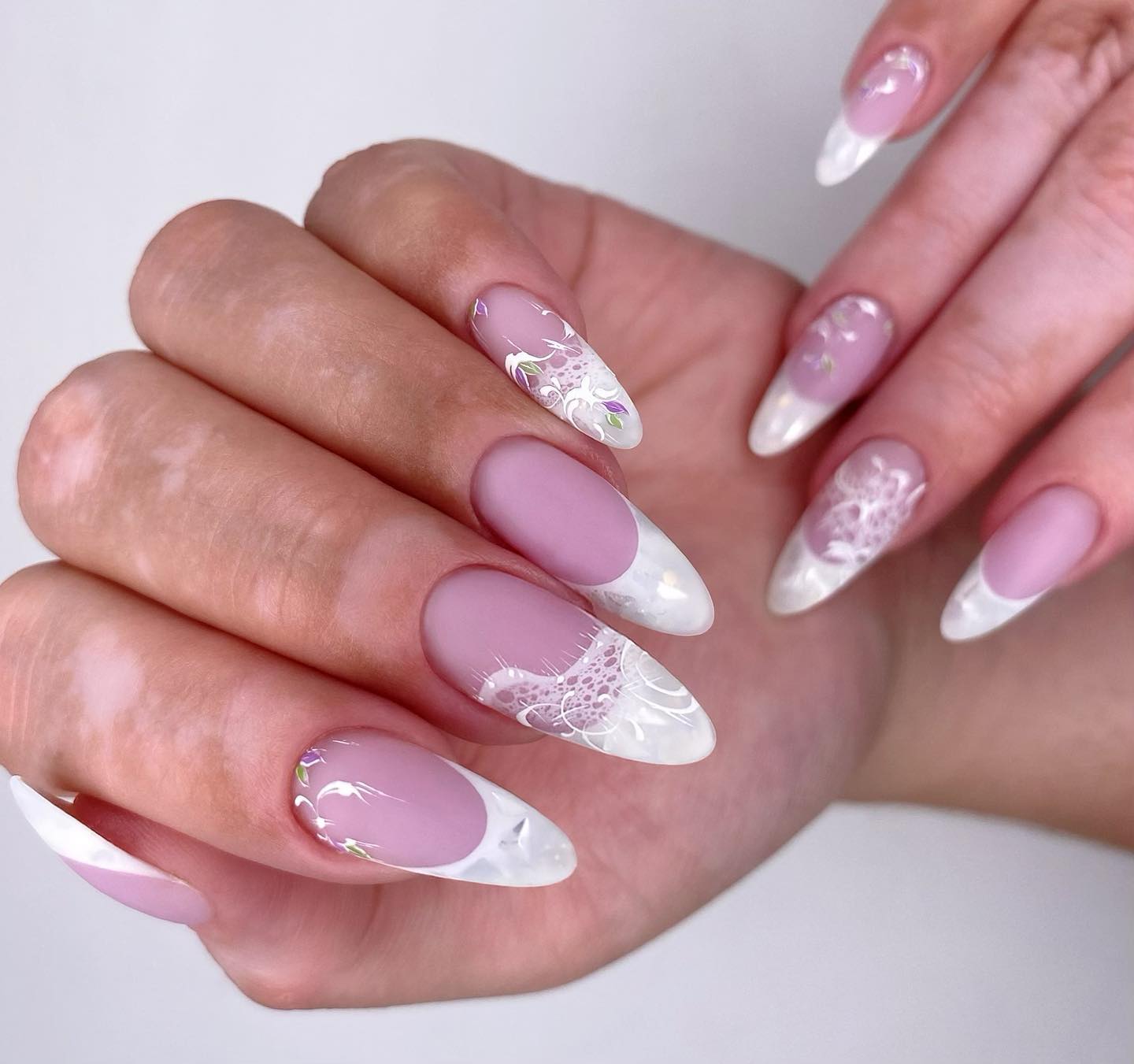 Brides who like to have long almond nails will adore these wedding nails. Being one of the classics, a French mani is taken to a different level with matte nail polish and some white lace nail art on top it.