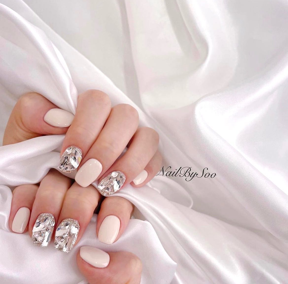 Short square nails are quite simple and it is easy to achieve a chic look with them. In order to achieve a cooler look, all you need to do is cover some of your nails with shiny stones. No one will take their eyes off you.